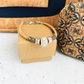 Pulsera de corcho cuero vegano detalles de zamac y dije con brillitos